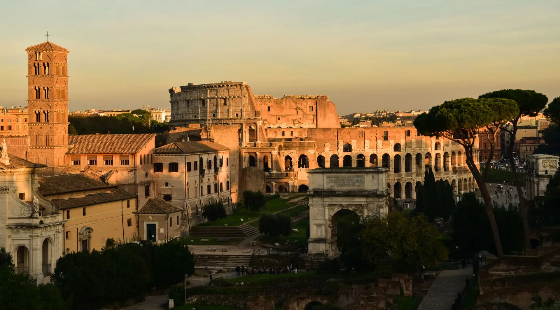 The Colosseum glowing in late-afternoon golden light.